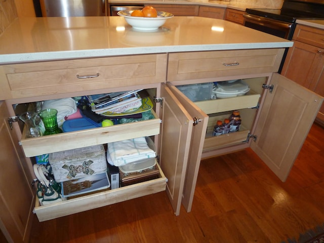 interior details with a center island, dark hardwood / wood-style flooring, and black electric range