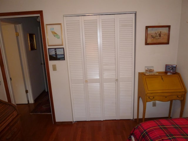 bedroom featuring dark hardwood / wood-style flooring and a closet