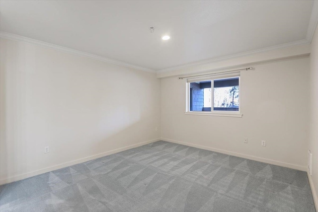 carpeted spare room with crown molding