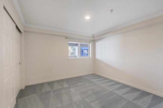 carpeted spare room with crown molding