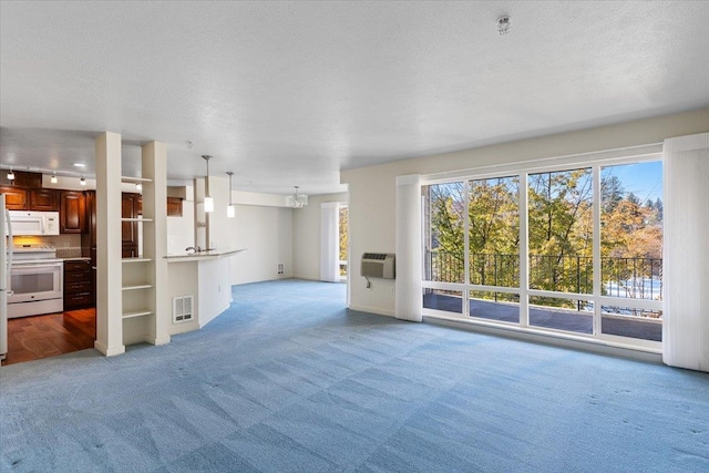 unfurnished living room featuring carpet flooring and a textured ceiling