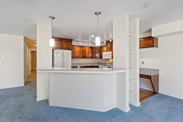 kitchen featuring light colored carpet, kitchen peninsula, rail lighting, pendant lighting, and white appliances