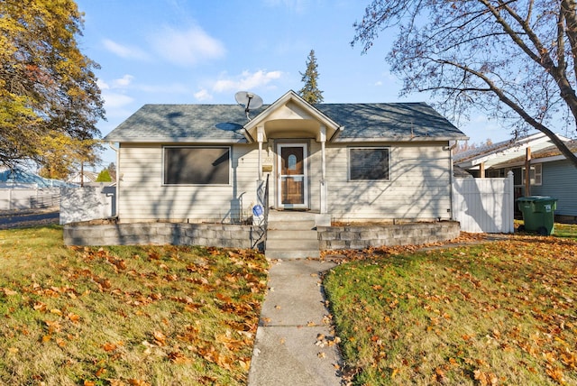 bungalow-style home with a front yard