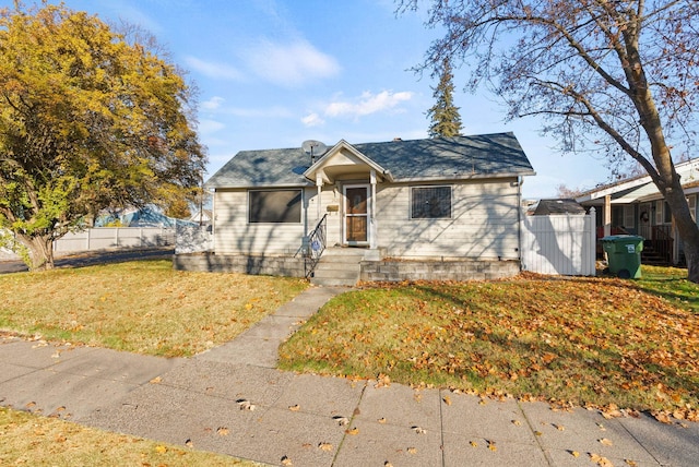 bungalow-style house with a front lawn