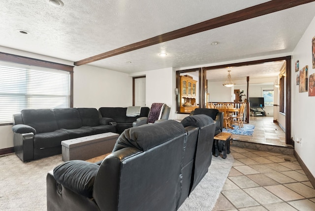 living room featuring a textured ceiling and light tile patterned floors