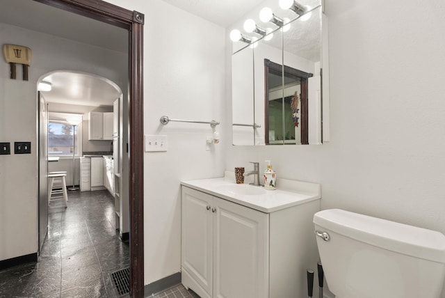 bathroom with toilet and vanity