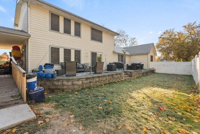 rear view of house featuring a patio area and a lawn