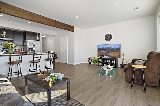 living room with hardwood / wood-style flooring and beam ceiling