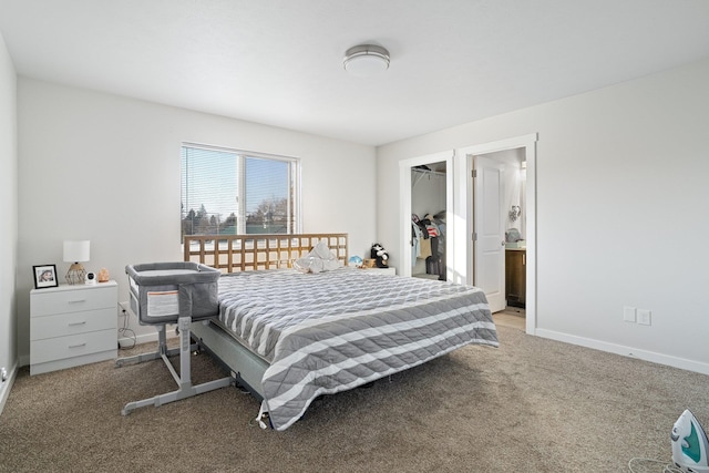 bedroom featuring a closet, a walk in closet, and light carpet