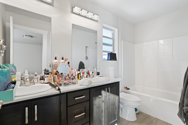 full bathroom featuring hardwood / wood-style floors, washtub / shower combination, vanity, and toilet