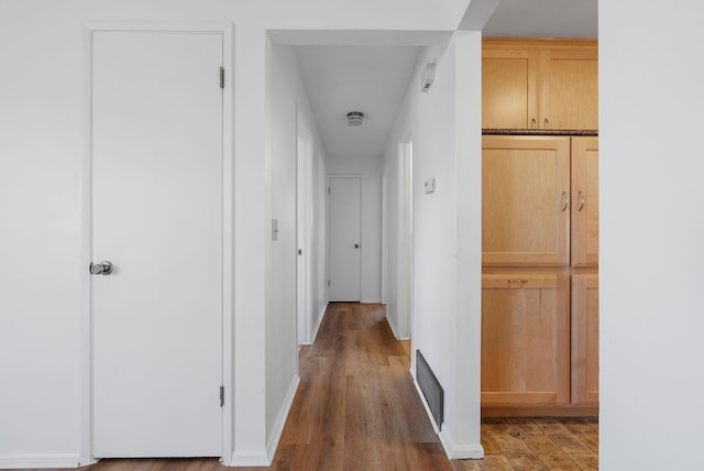 corridor featuring baseboards and visible vents