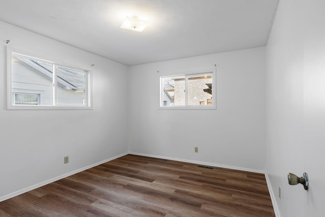 empty room with wood finished floors and baseboards