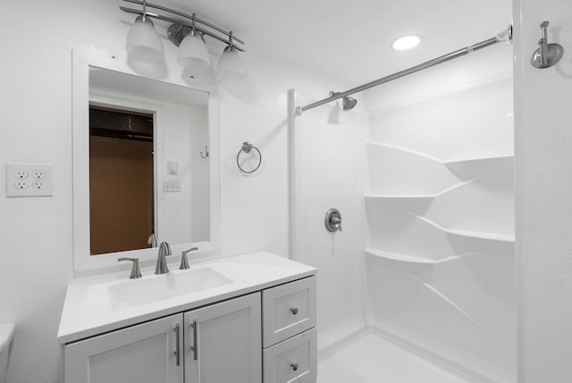 bathroom featuring a stall shower and vanity