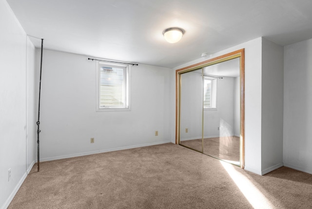 unfurnished bedroom featuring a closet and carpet flooring