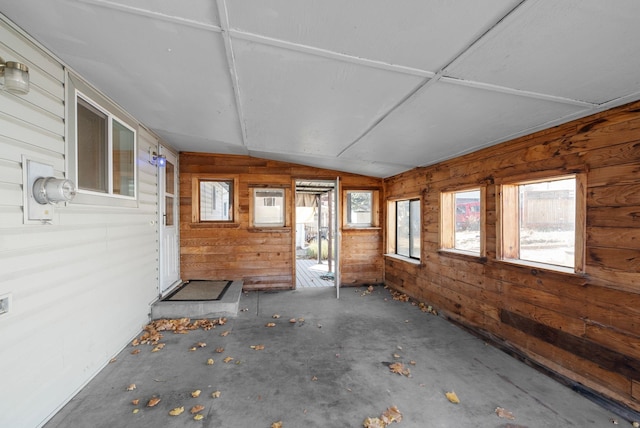 unfurnished sunroom featuring a healthy amount of sunlight and vaulted ceiling