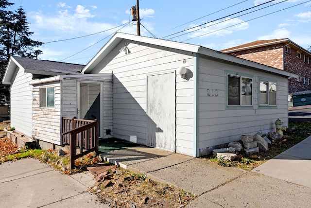 exterior space with a shingled roof