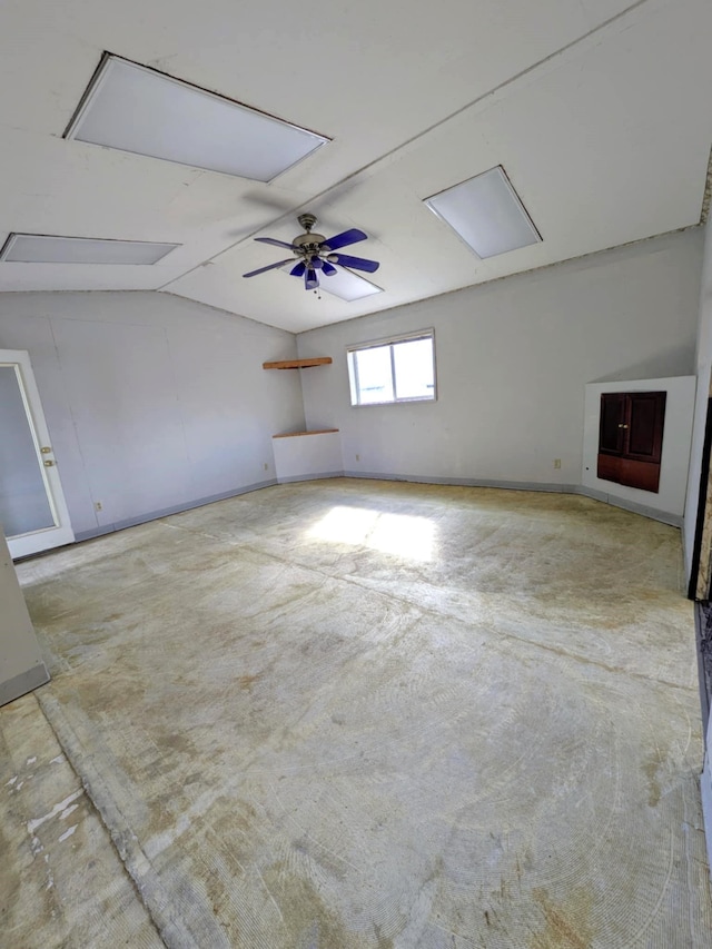 interior space featuring vaulted ceiling, concrete floors, and a ceiling fan