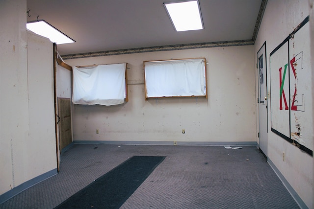 empty room featuring dark carpet