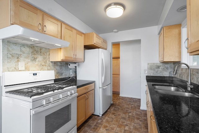 kitchen with decorative backsplash, light brown cabinets, white appliances, and sink