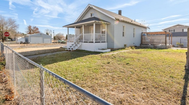 bungalow with covered porch and a front yard