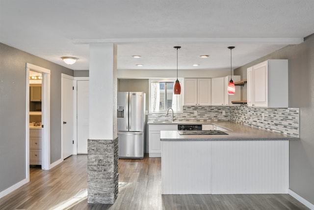 kitchen with white cabinetry, stainless steel fridge, and dark hardwood / wood-style floors