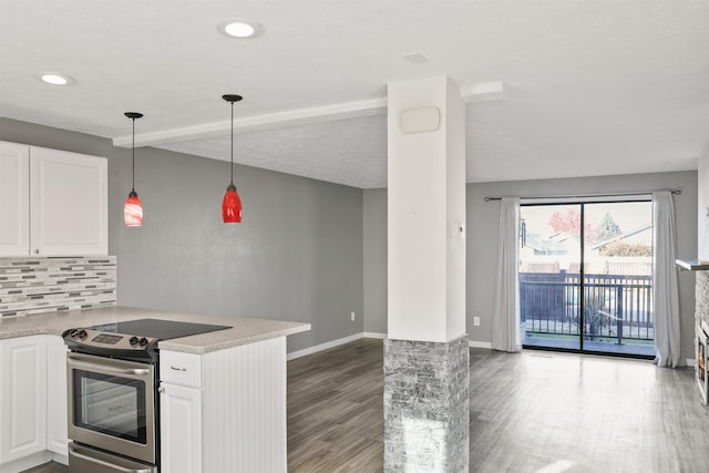 kitchen featuring white cabinetry, electric stove, hanging light fixtures, hardwood / wood-style flooring, and kitchen peninsula