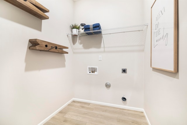 laundry area with wood-type flooring, hookup for a washing machine, hookup for a gas dryer, and hookup for an electric dryer