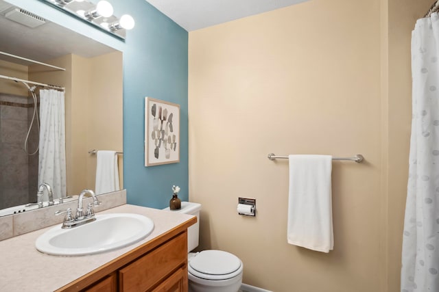 bathroom featuring toilet, vanity, and a shower with shower curtain