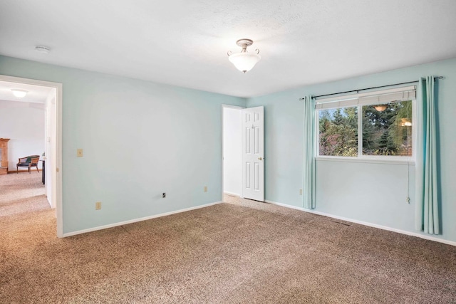 unfurnished room with carpet flooring