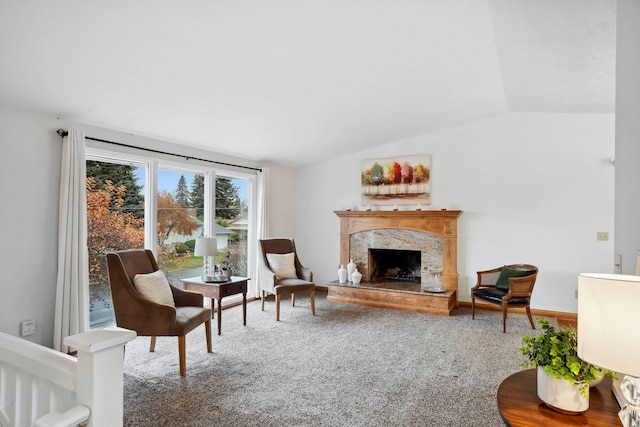 carpeted living room featuring lofted ceiling and a fireplace