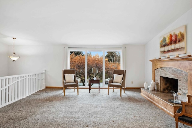 living area featuring carpet and a fireplace