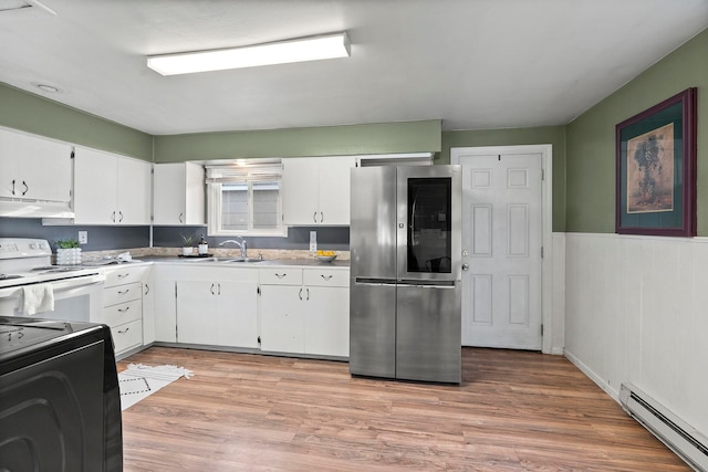 kitchen with stainless steel refrigerator, sink, baseboard heating, white range with electric cooktop, and white cabinets