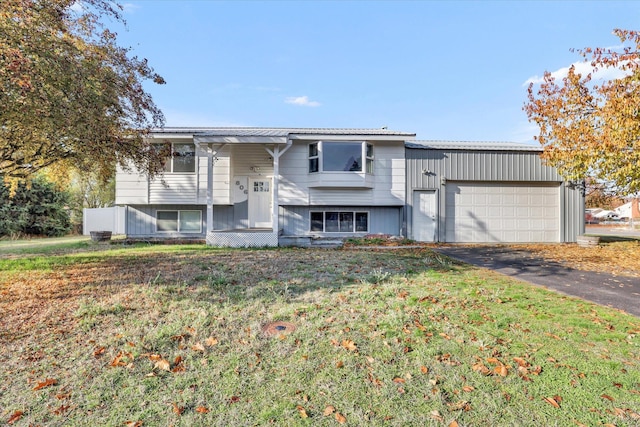 split foyer home featuring a front lawn and a garage