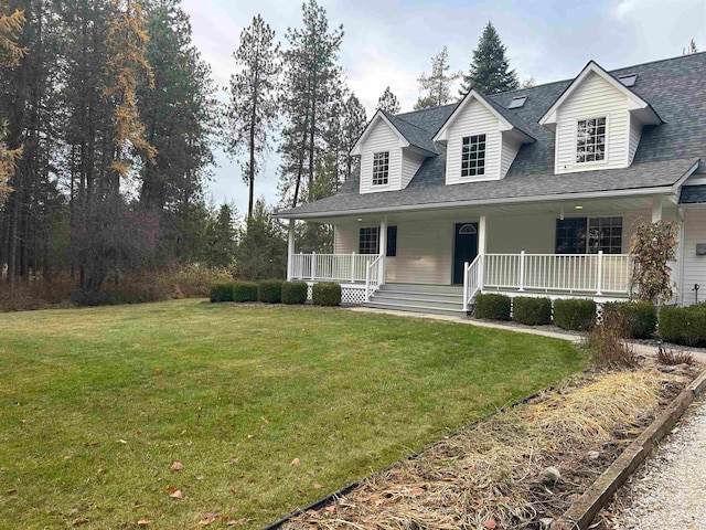 view of front facade featuring covered porch and a front yard