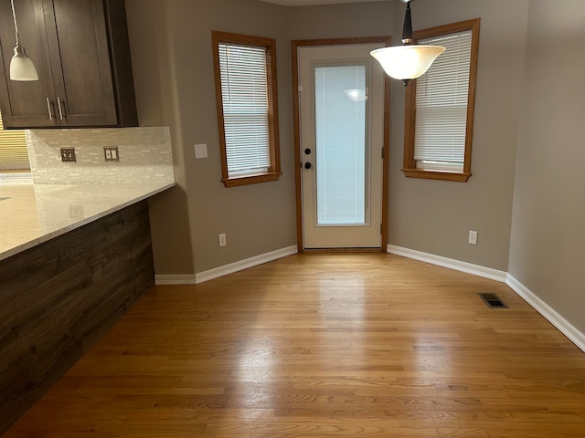 unfurnished dining area with light hardwood / wood-style flooring