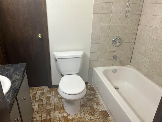 full bathroom with vanity, tiled shower / bath combo, and toilet