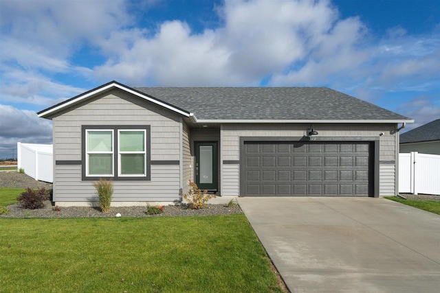 ranch-style house featuring a garage and a front lawn