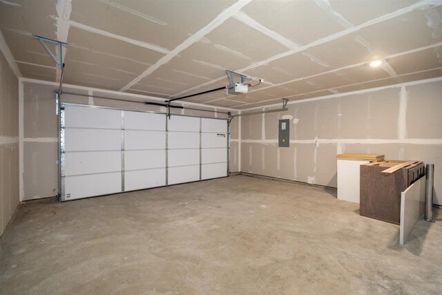 garage with a garage door opener and electric panel