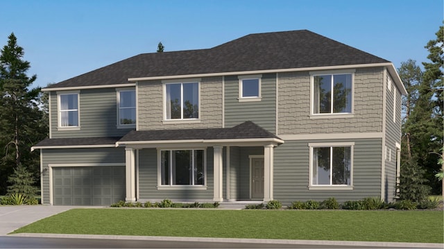 view of front of house featuring a garage and a front lawn