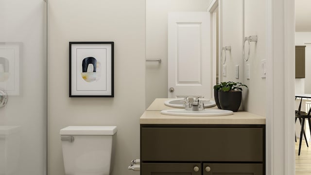 bathroom featuring wood-type flooring, vanity, and toilet