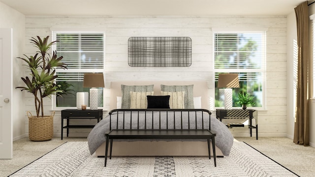 carpeted bedroom featuring wood walls