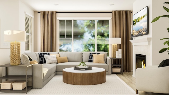 living area featuring light wood-type flooring and a tile fireplace