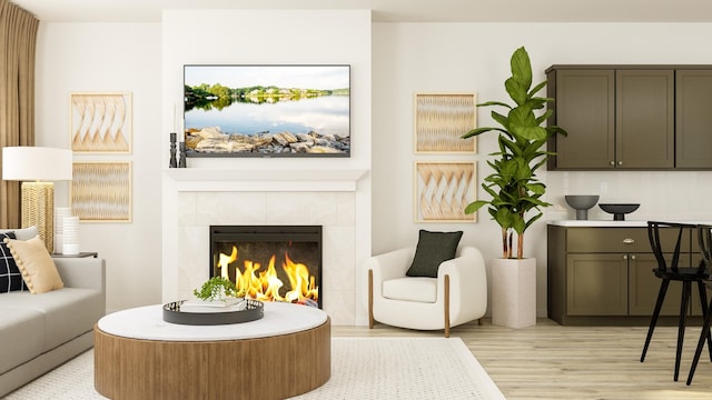 living area featuring light hardwood / wood-style floors and a tile fireplace