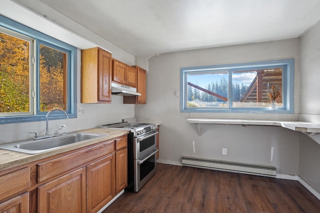 kitchen featuring double oven range, baseboard heating, dark wood-type flooring, and sink