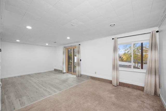 unfurnished room featuring light wood-type flooring and ornamental molding