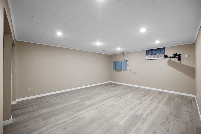 basement featuring hardwood / wood-style flooring and ornamental molding