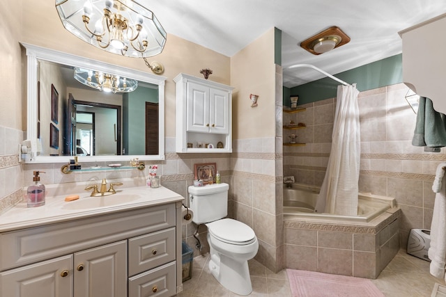 full bathroom featuring tile patterned floors, vanity, shower / bath combo with shower curtain, tile walls, and toilet