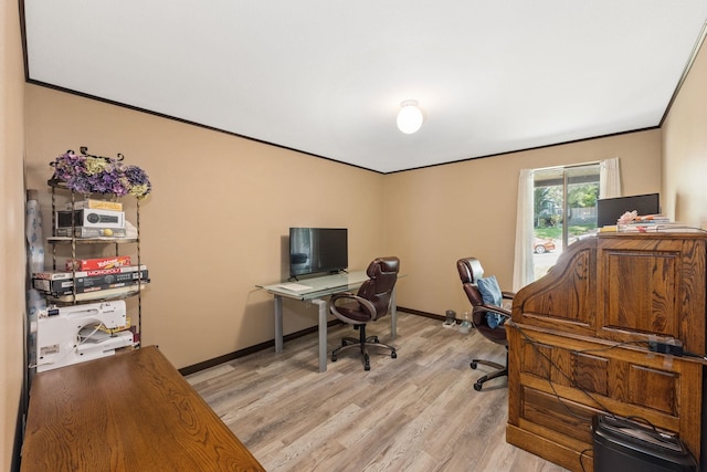 office area with light hardwood / wood-style flooring and ornamental molding