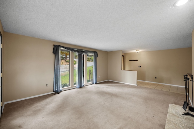 carpeted spare room featuring a textured ceiling