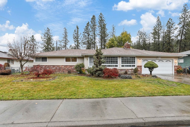 ranch-style home with a garage and a front lawn